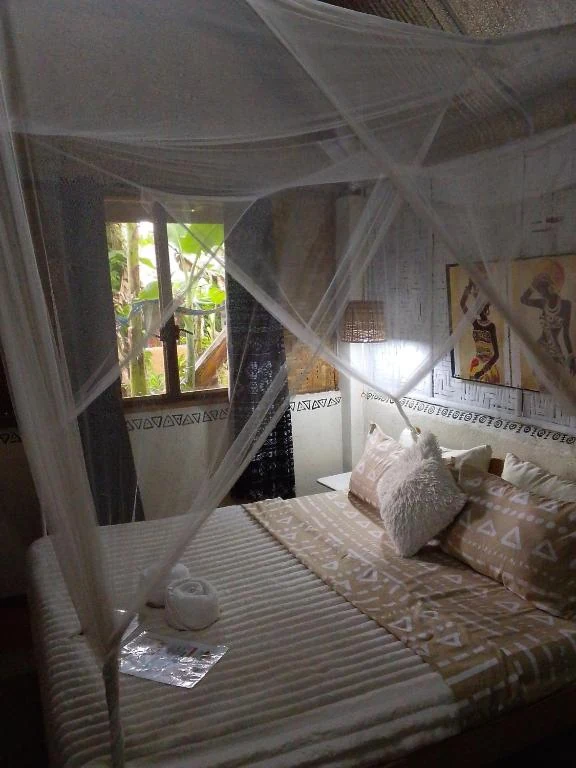 Canopy bed beside the garden-facing window — Family Room with Garden View