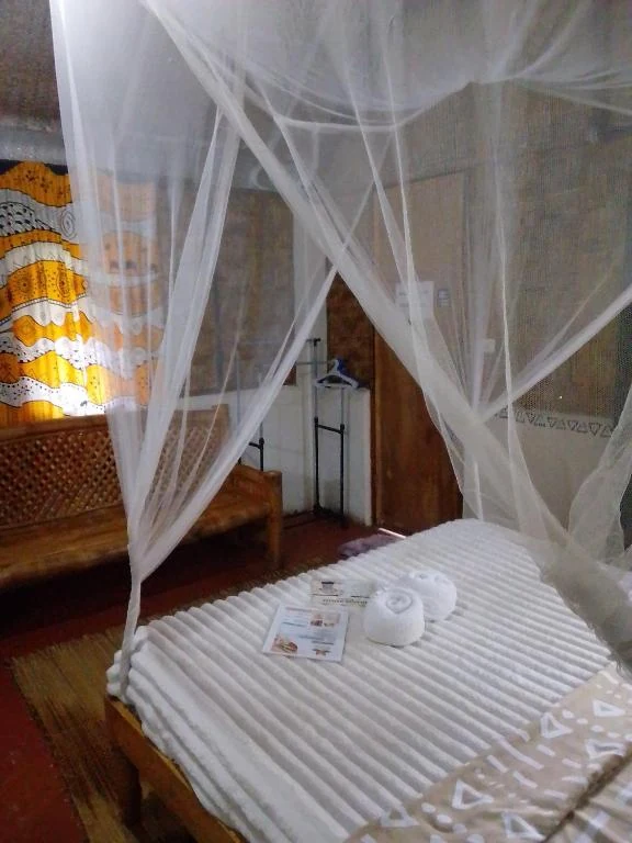 Canopy bed, woven walls and wardrobe — Family Room with Garden View