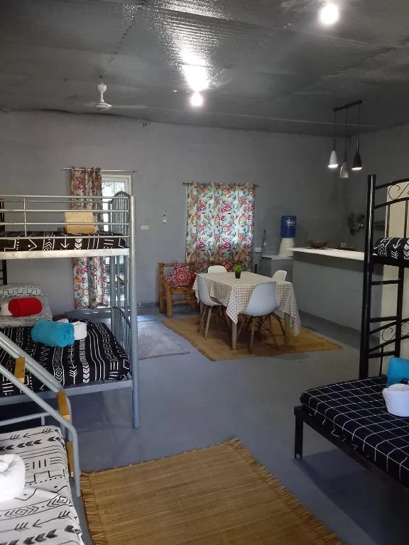 Wide view of the beds, dining table and counter — Family Room