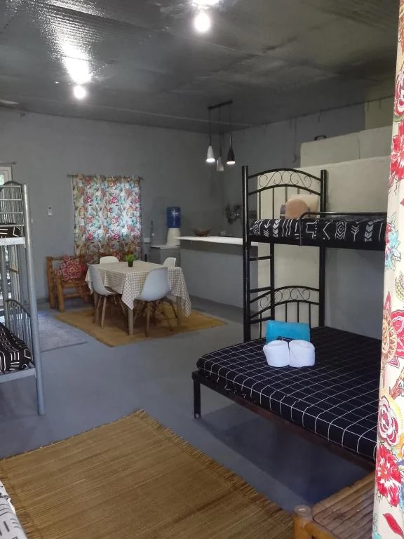 Bedroom with bunk beds, dining table and seating — Family Room