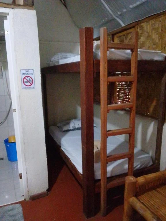 Wooden bunk beds beside the bathroom doorway — Family Room with Garden View