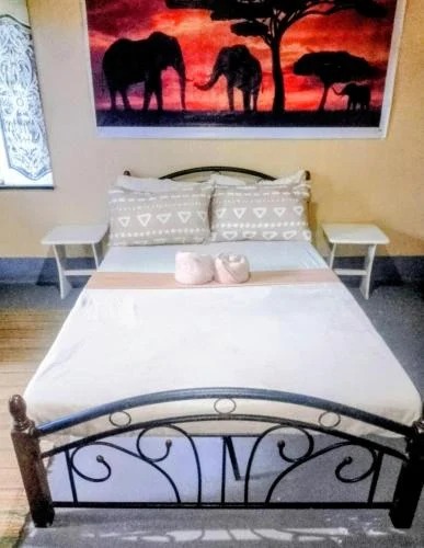 Economy Double Room bed and artwork